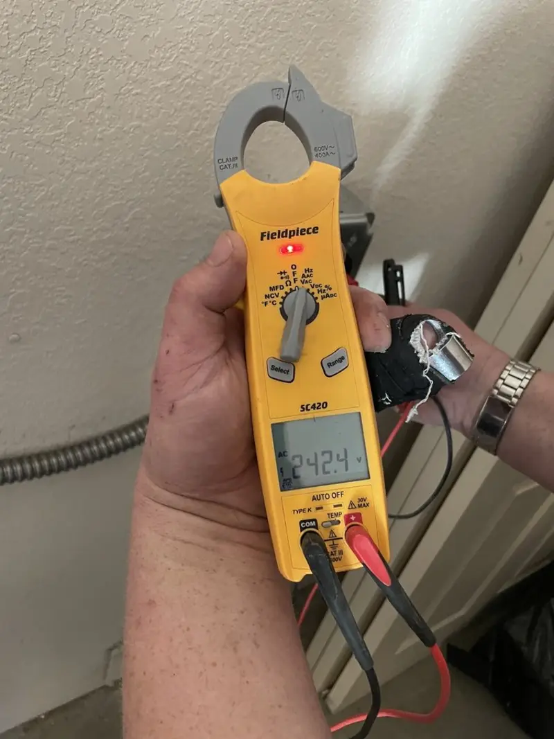 Voltage testing with clamp meter during Ceiling Fan Installation in Bentonville